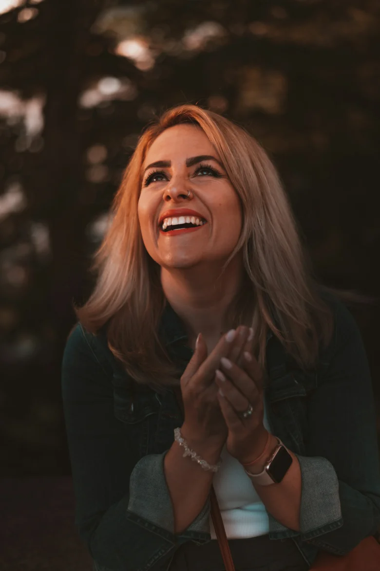 Woman in a black top smiling warmly